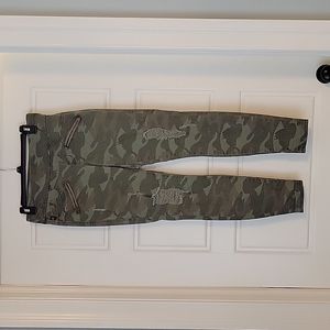 Edgy Camouflage Stretch Jeans with Distressing and Faux Zipper Pockets, Size 8.